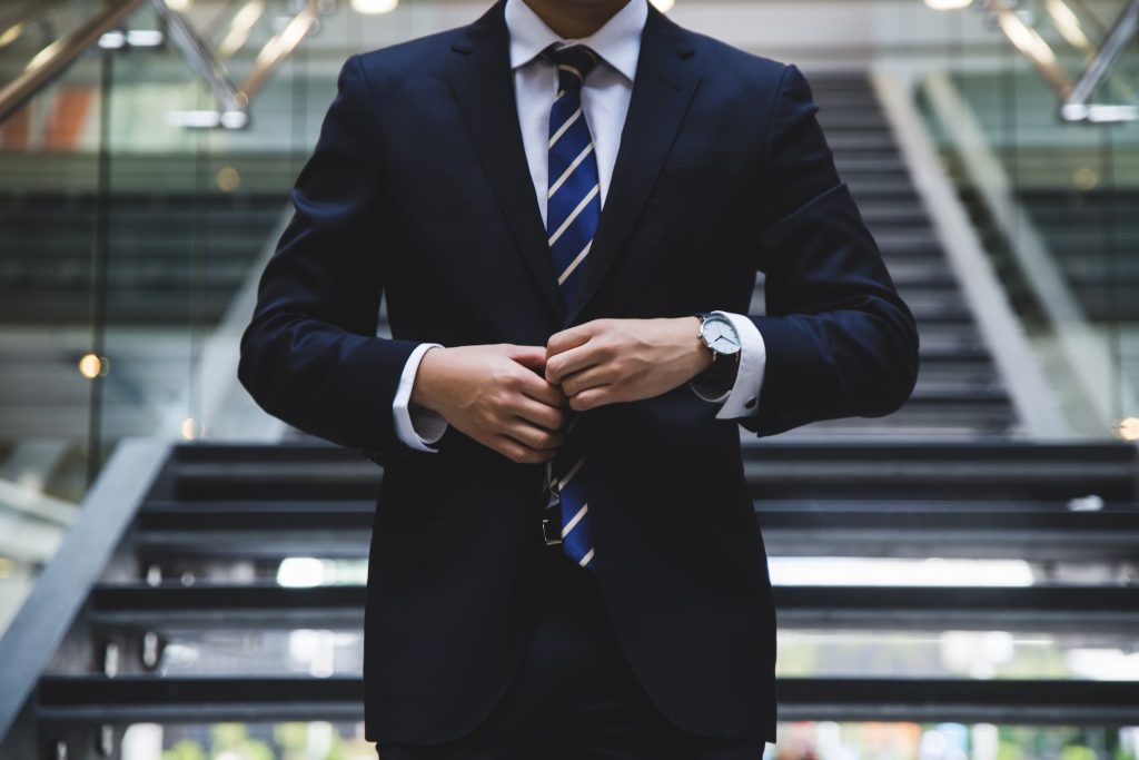 man in suit walking down stairs